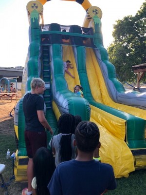 kids playing on a blow up slide